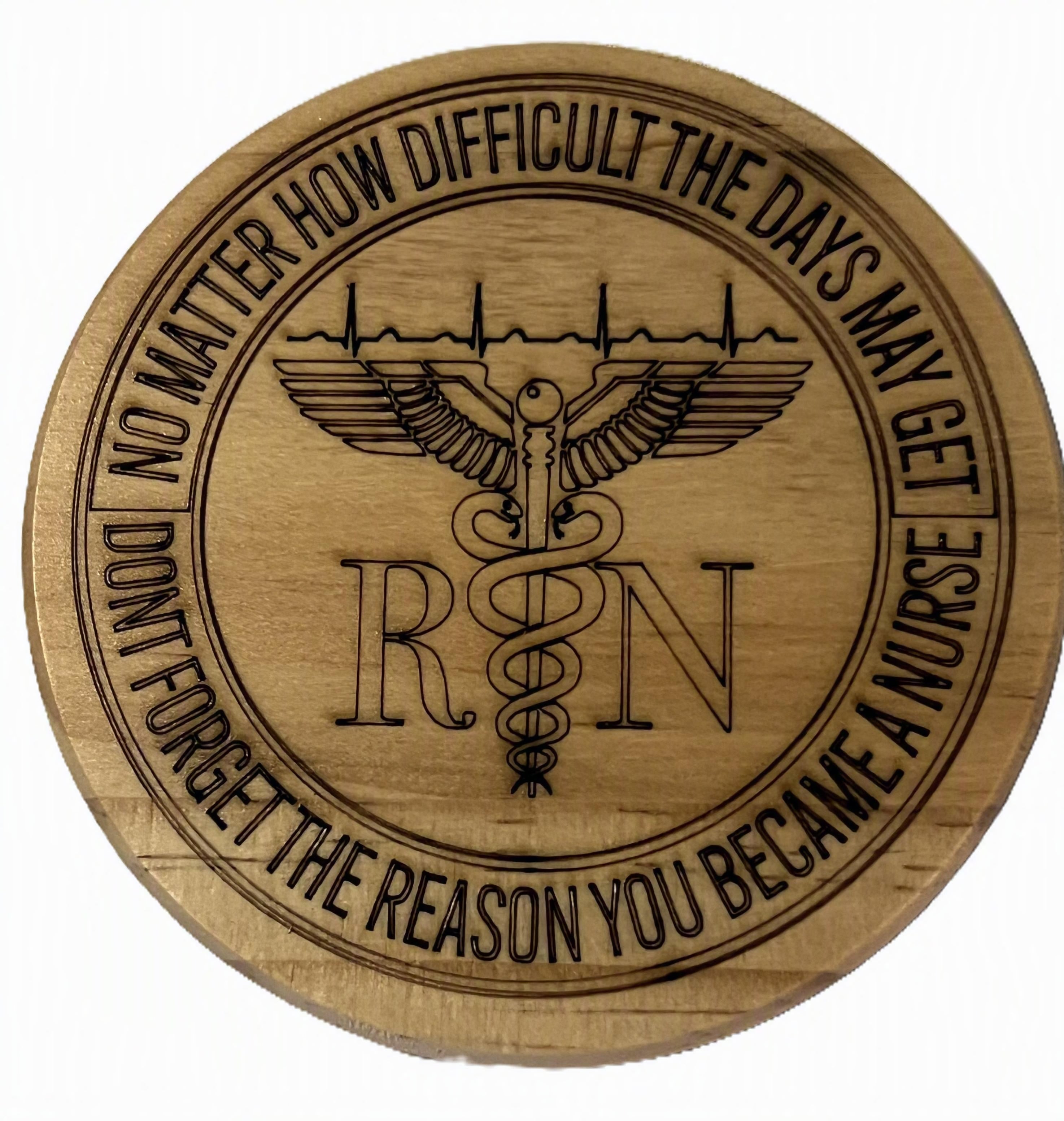 A round wooden coaster featuring a laser-engraved RN medical symbol with a caduceus wing design and motivational text around the border.